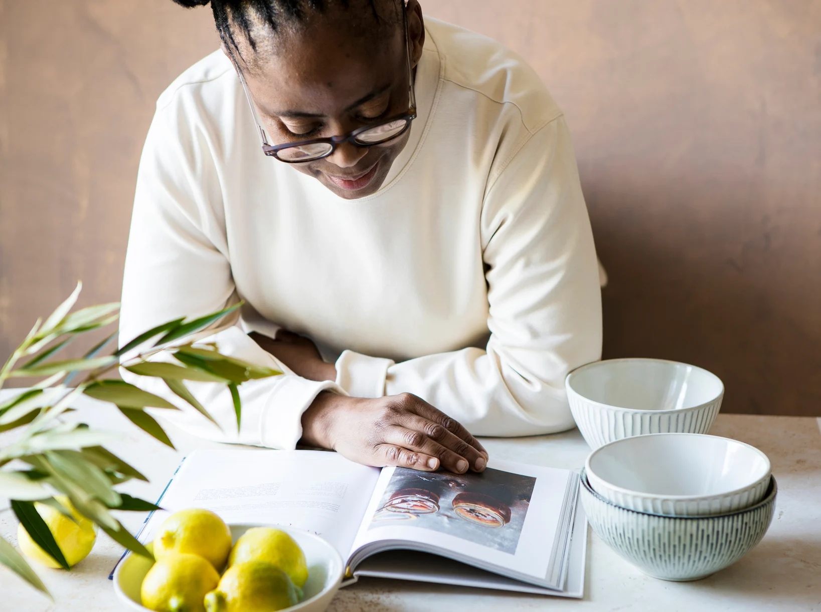 Casual Woman Cook Reading A Cookbook In Her Kitchen 3912145