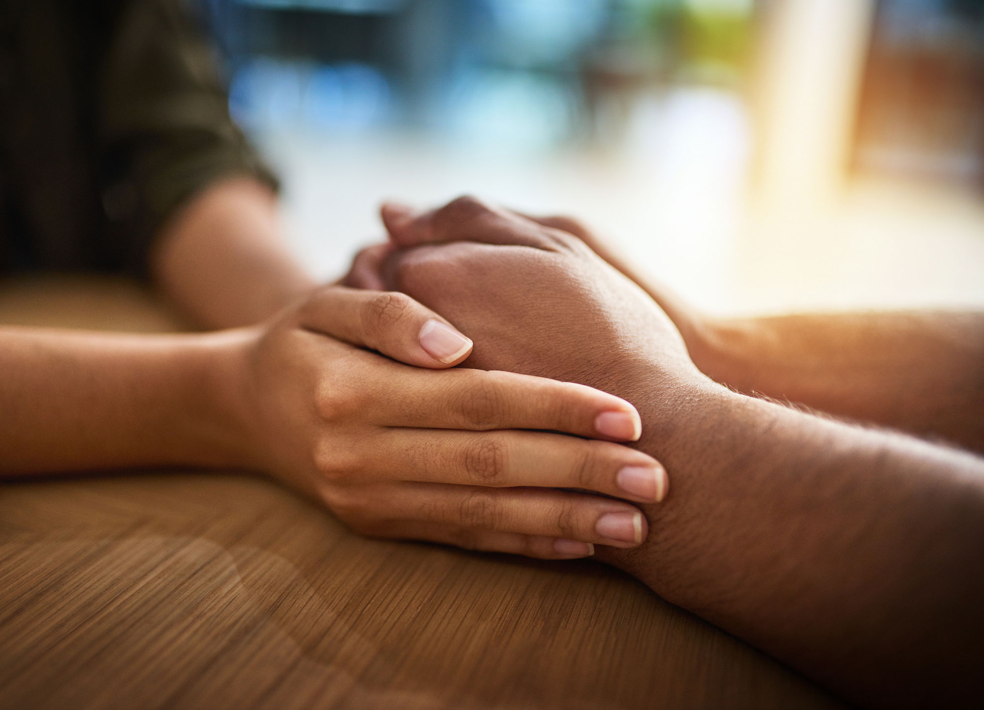 Two people holding hands, showing emotional support and connection on how to help someone with an eating disorder.
