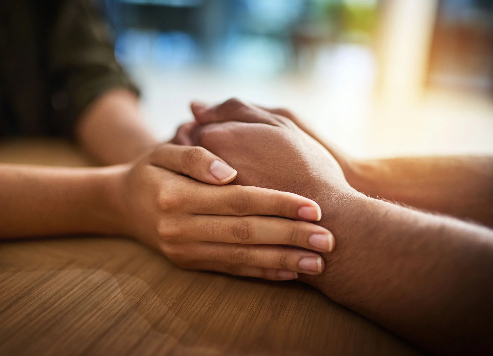 two people holding hands, showing emotional support and connection on how to help someone with an eating disorder.
