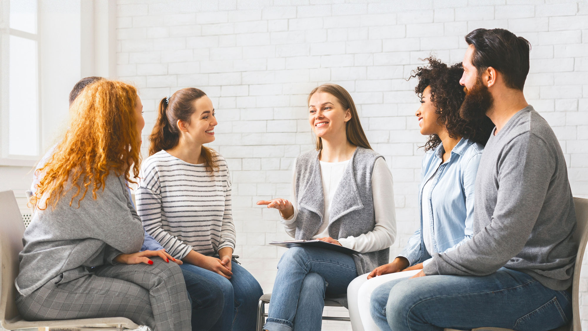 Adults in a group session discussing healthy eating habits in a supportive environment to help treat eating disorders