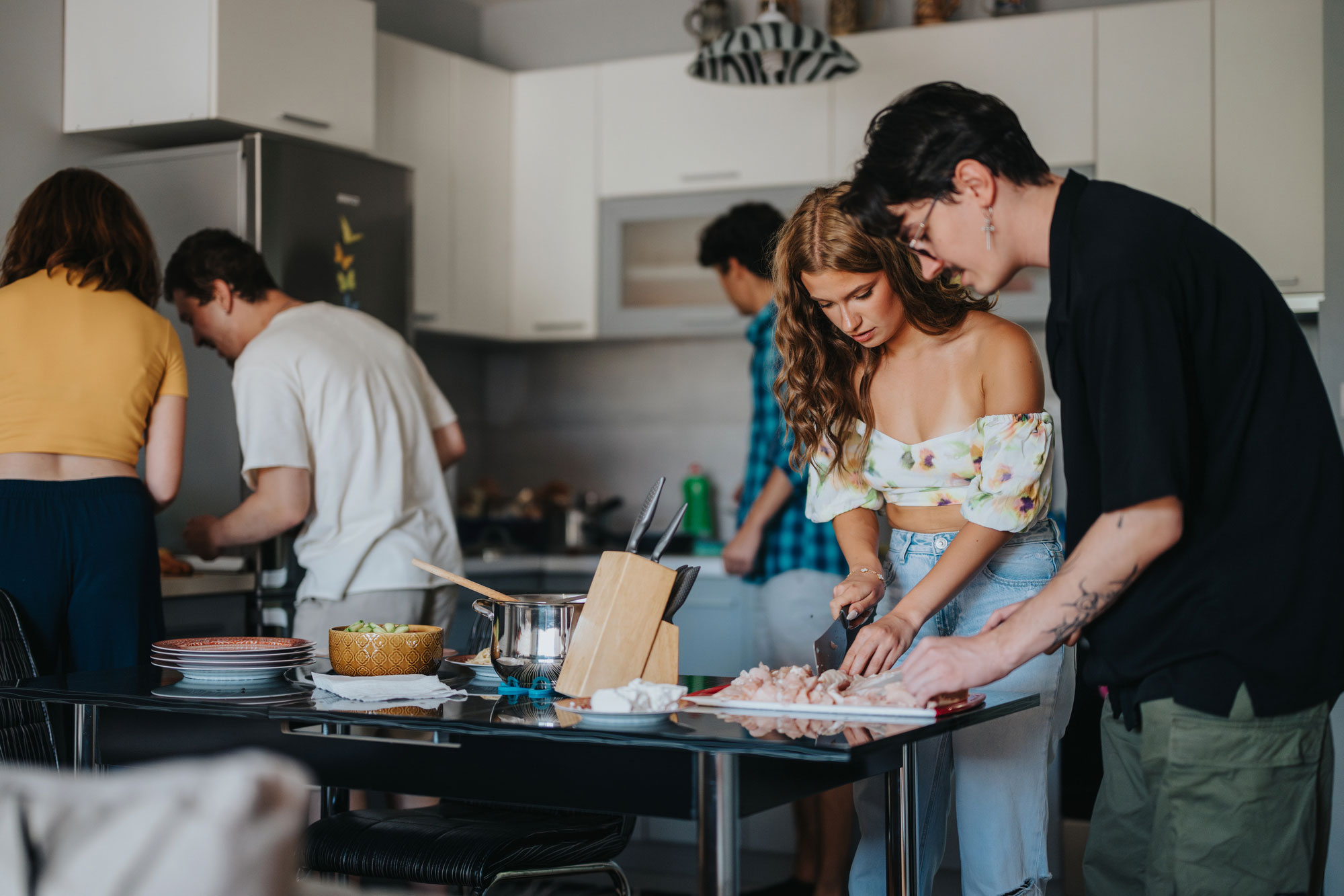 Young adults cooking together in a kitchen, part of a supportive program addressing eating disorder symptoms