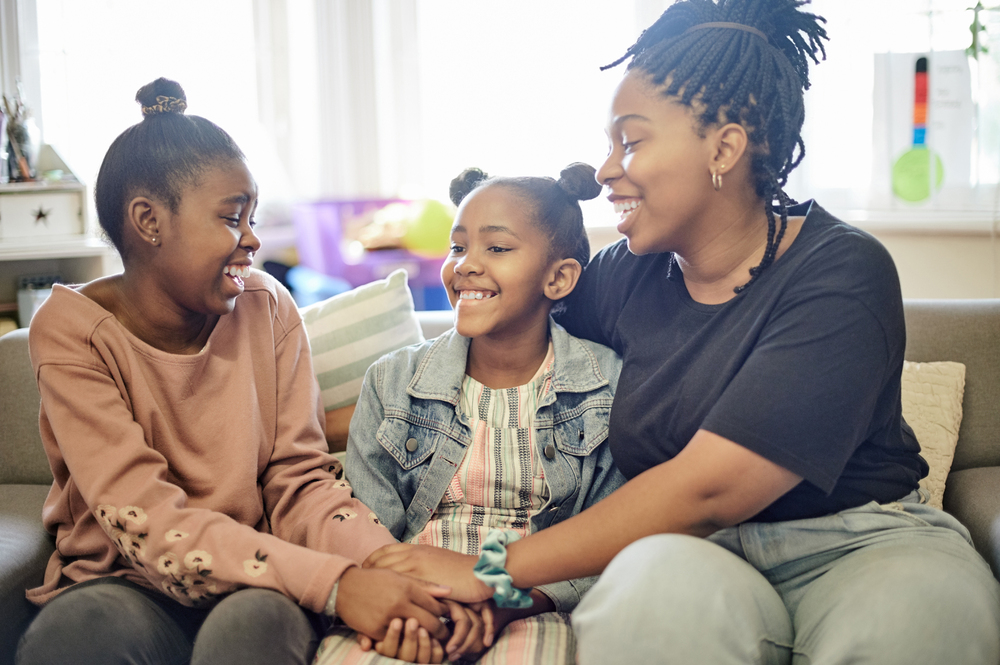 black family, affectionate and unity with woman and girls at home for joyful, carefree or support.